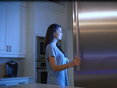 Woman opening fridge