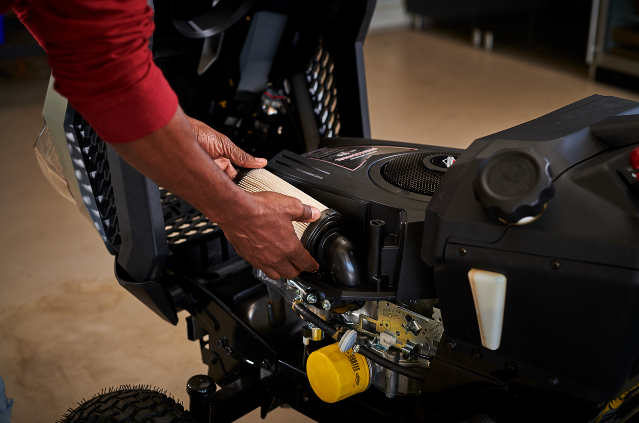 Person servicing their Briggs & Stratton riding mower engine.